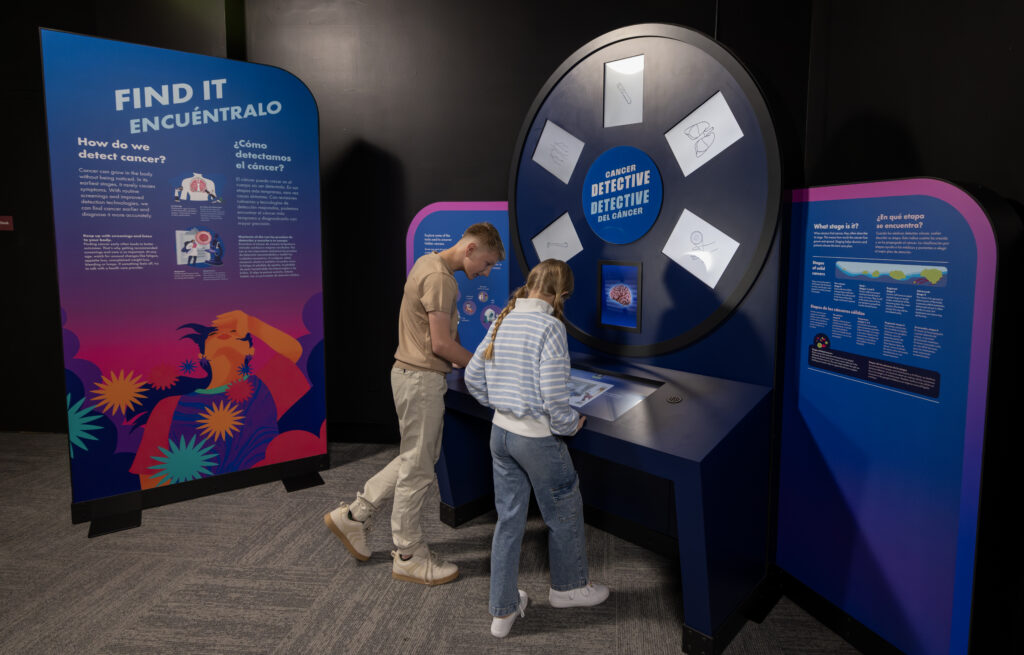 Visitors become “cancer detectives” in a hunt to unmask or rule out hidden cancers. Would-be sleuths apply screening and evaluation tools to different tissues. The interactive highlights the importance of routine screenings and paying attention to unusual symptoms. (Photo: The Journey to End Cancer)